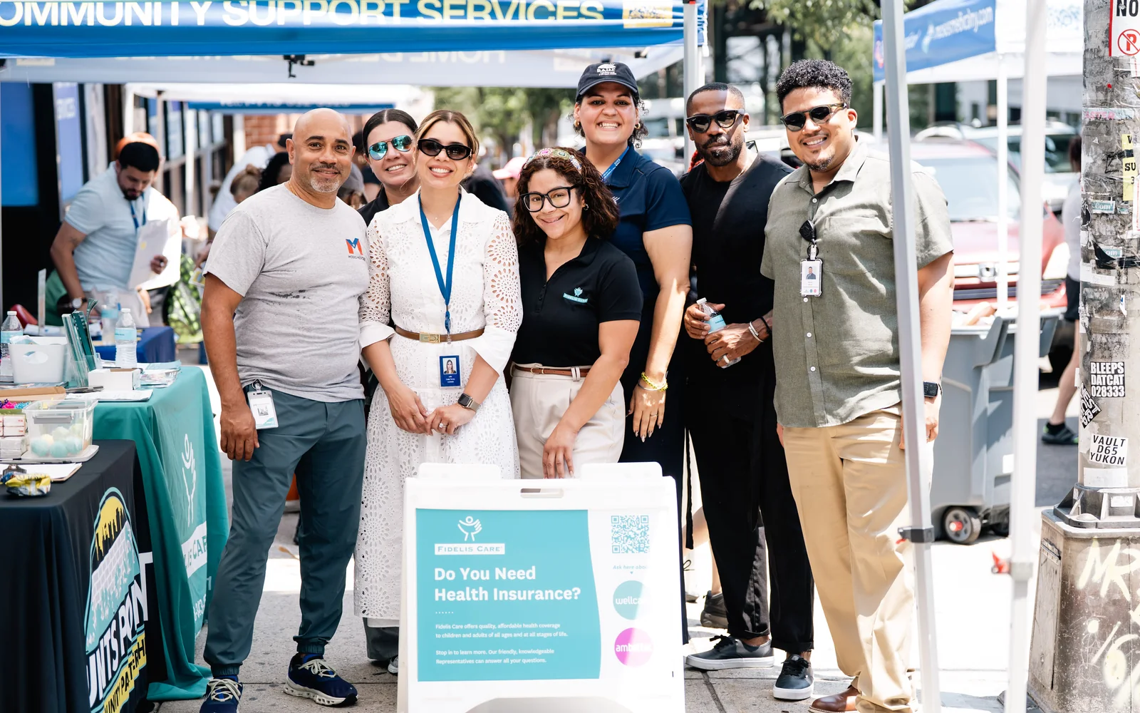 Adult community members talking outside Moses Medical during Summer Health Day
