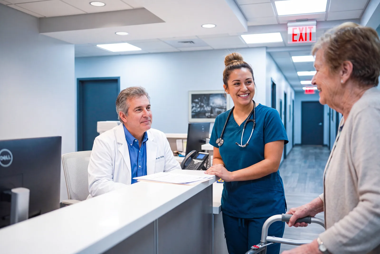 An older woman with a walker checking in at the clinic front desk
